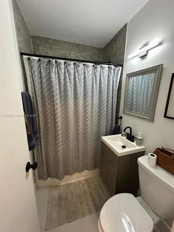 a bathroom with a sink toilet and mirror