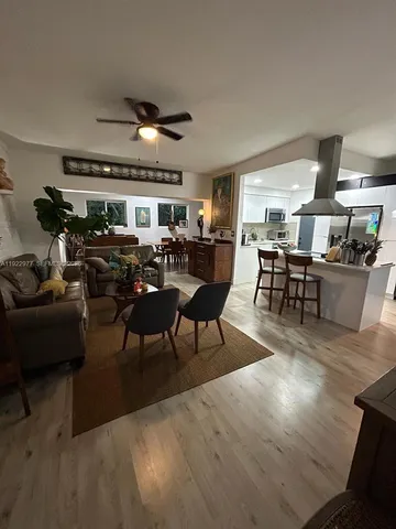 a living room with lots of furniture and a large window