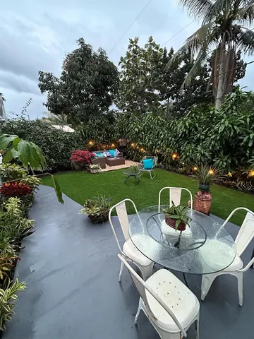 a view of a table and chairs in the garden