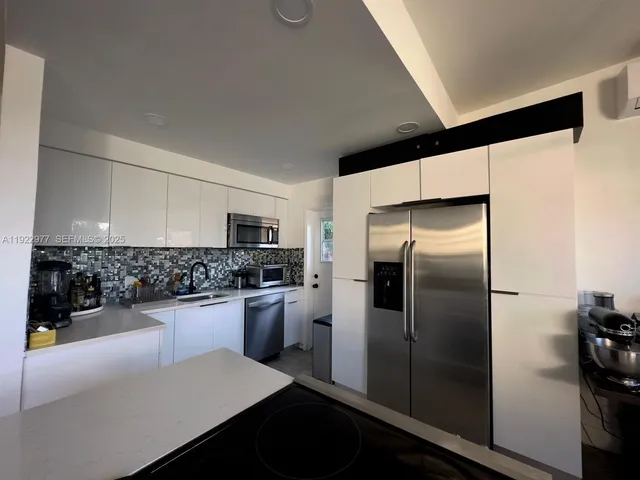 a kitchen with a refrigerator and a sink
