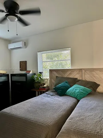 a bedroom with bed and window