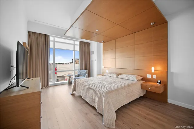 a bedroom with a bed and a flat screen tv