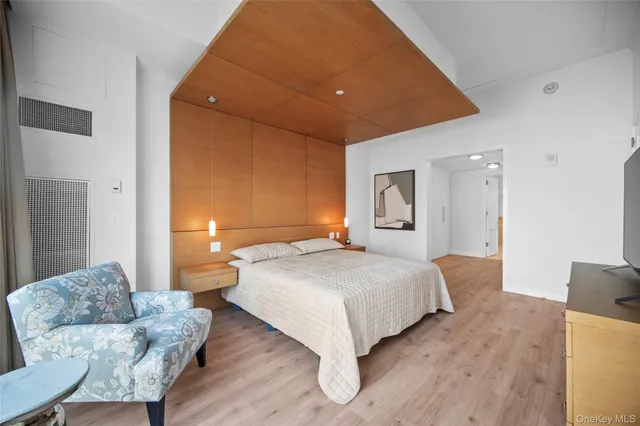 a bedroom with a bed and a couch