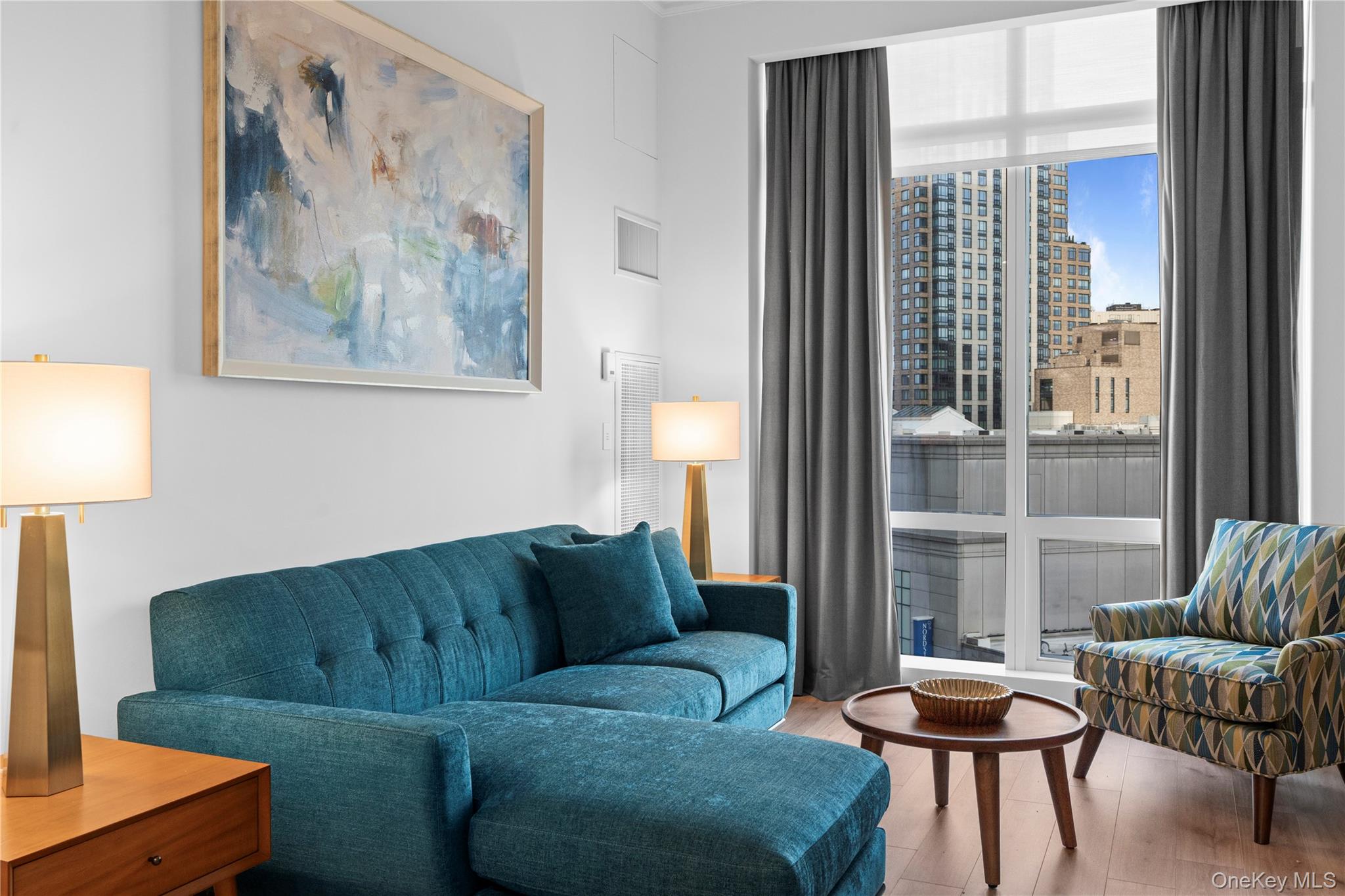 1 Renaissance Square, Unit 10B White Plains, NY 10601 - Photo 20 of 36 a living room with furniture and a large window
