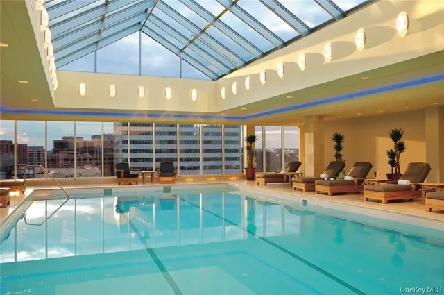 a view of a swimming pool with outdoor seating