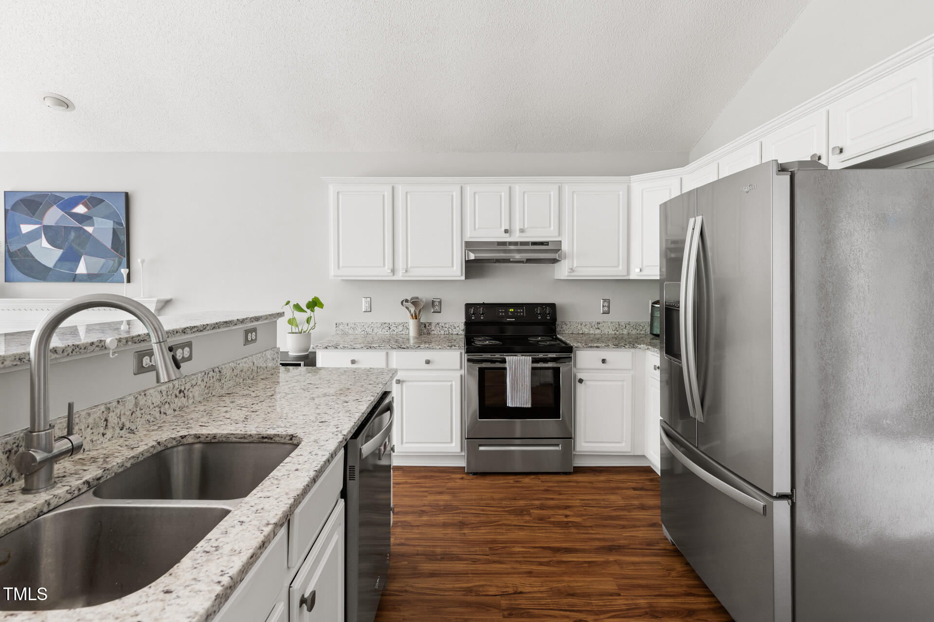 2301 Bolingbrook Lane Raleigh, NC 27613 - Photo 11 of 36 a kitchen with a refrigerator sink and cabinets