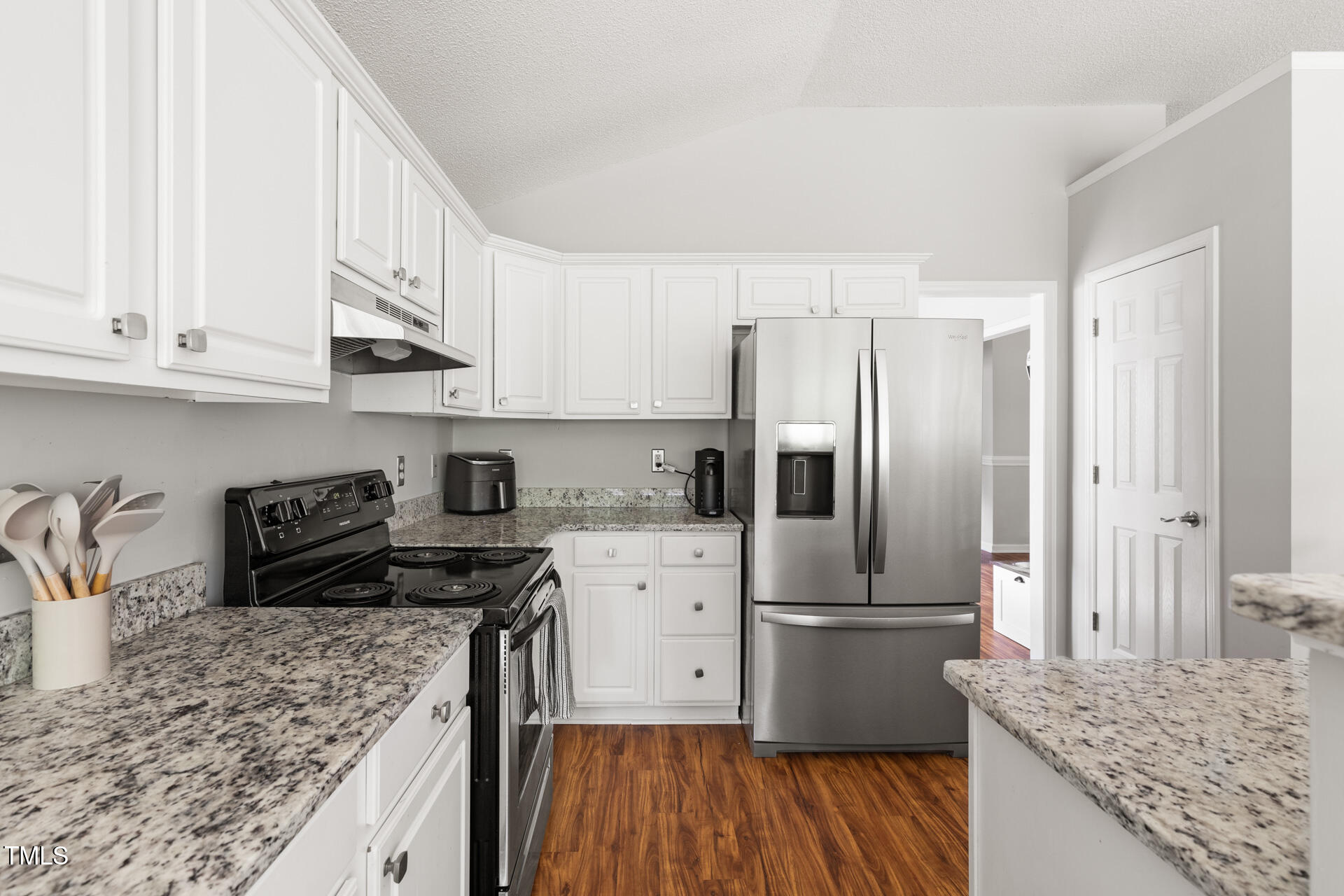 2301 Bolingbrook Lane Raleigh, NC 27613 - Photo 12 of 36 a kitchen with stainless steel appliances granite countertop a refrigerator stove and sink
