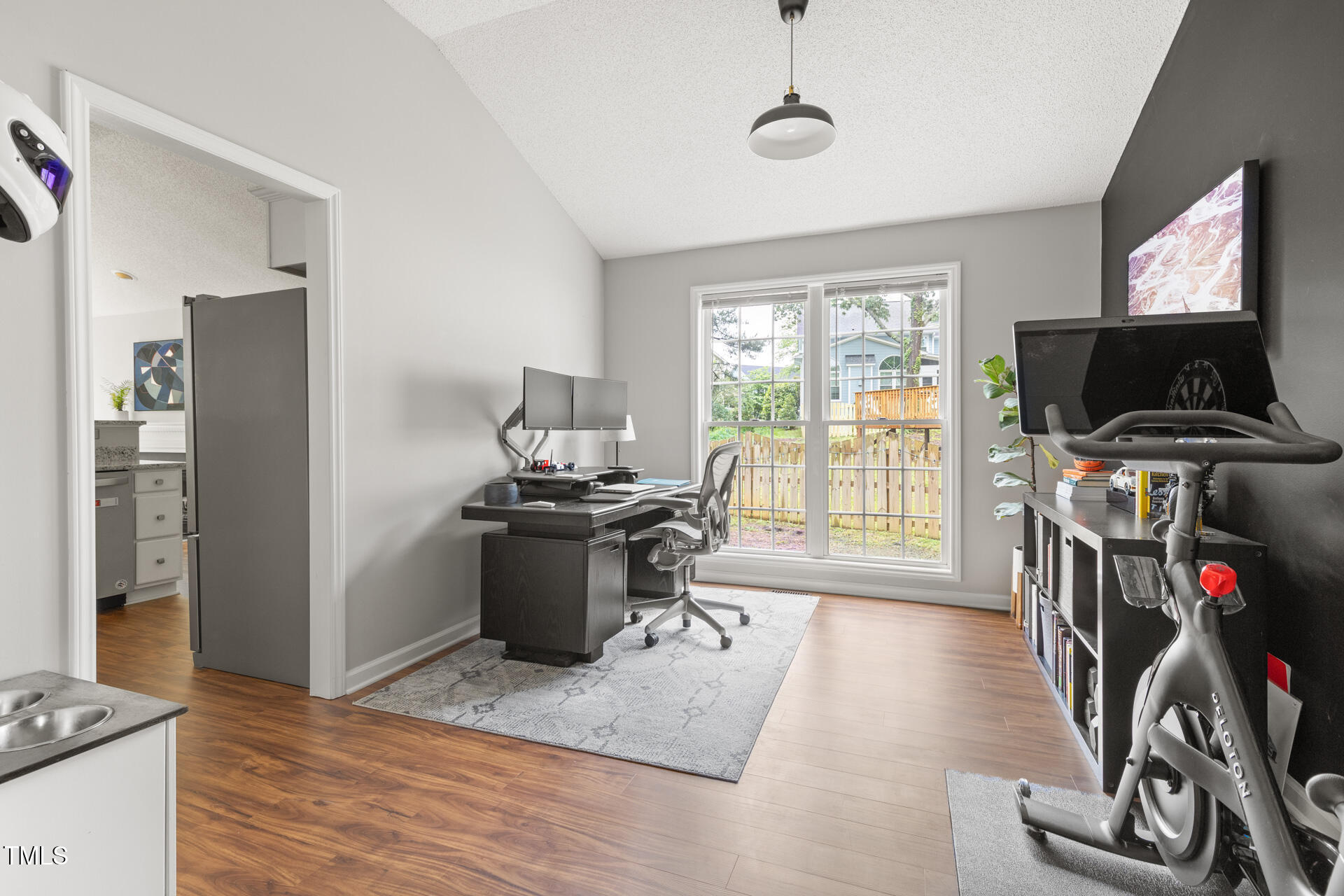 2301 Bolingbrook Lane Raleigh, NC 27613 - Photo 18 of 36 a view of a workspace with furniture and a flat screen tv