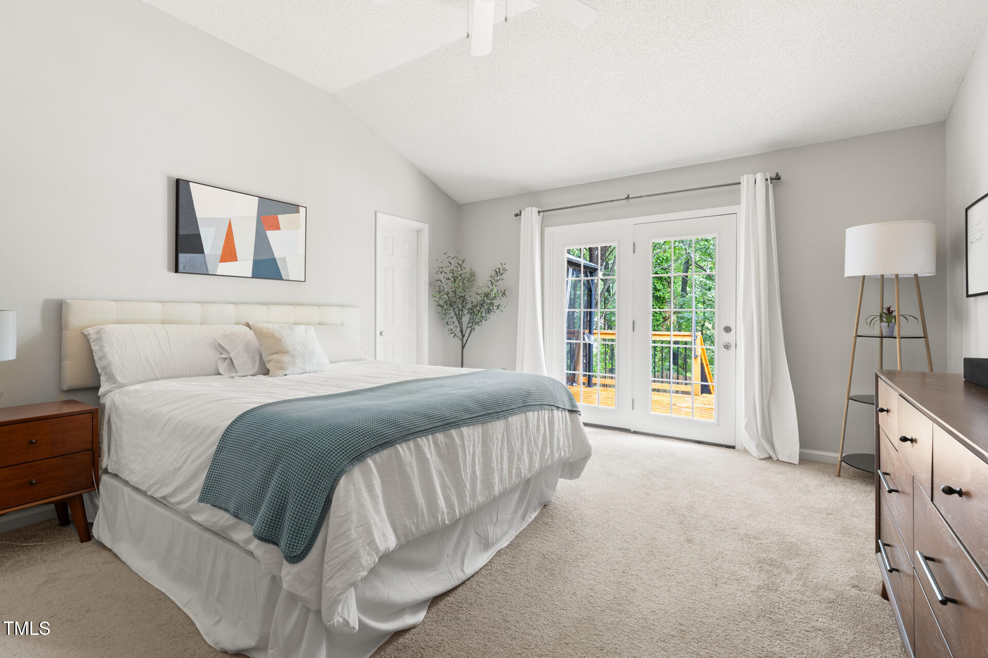 2301 Bolingbrook Lane Raleigh, NC 27613 - Photo 20 of 36 a spacious bedroom with a bed a couch and a window