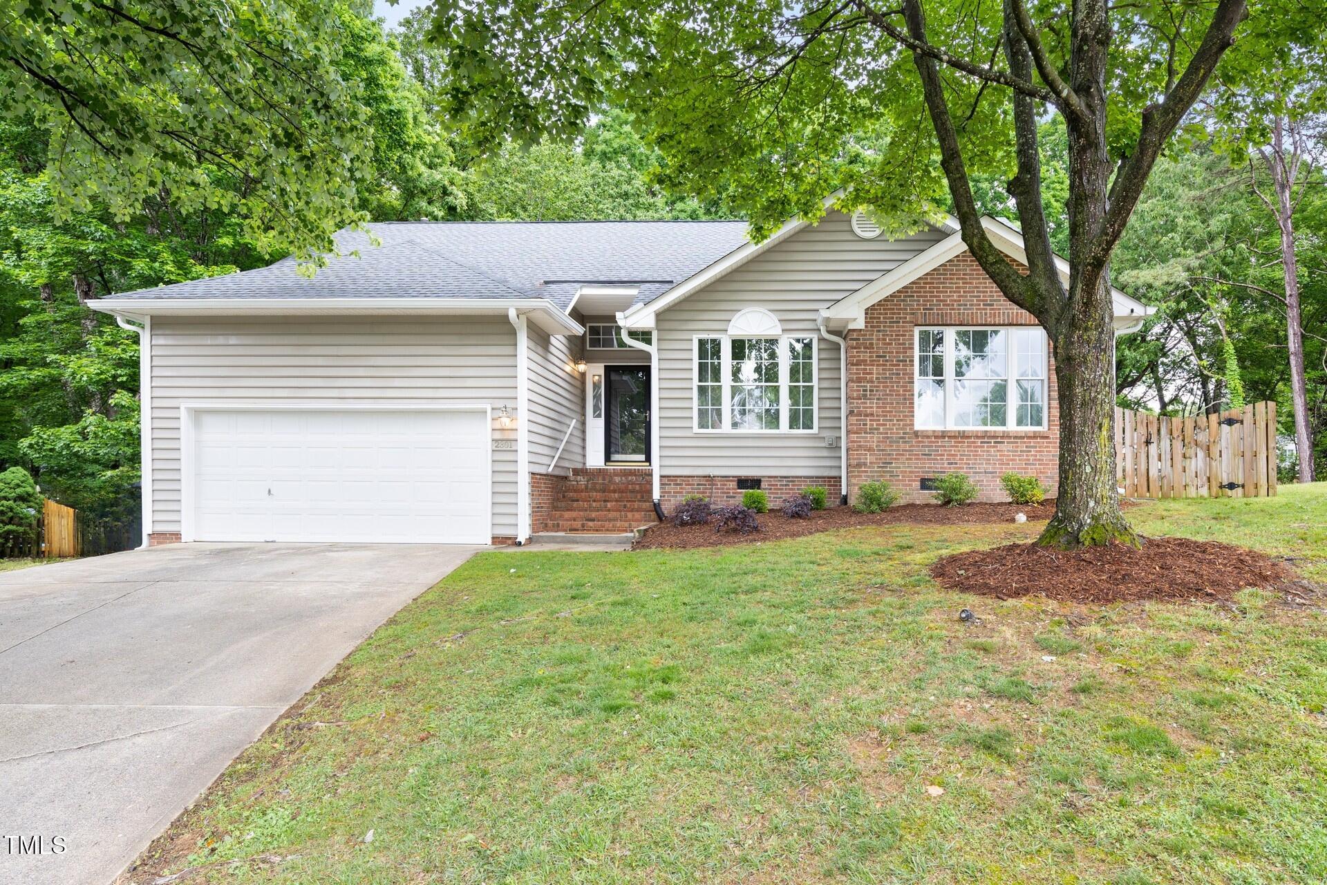 2301 Bolingbrook Lane Raleigh, NC 27613 - Photo 2 of 36 a front view of a house with a yard and garage