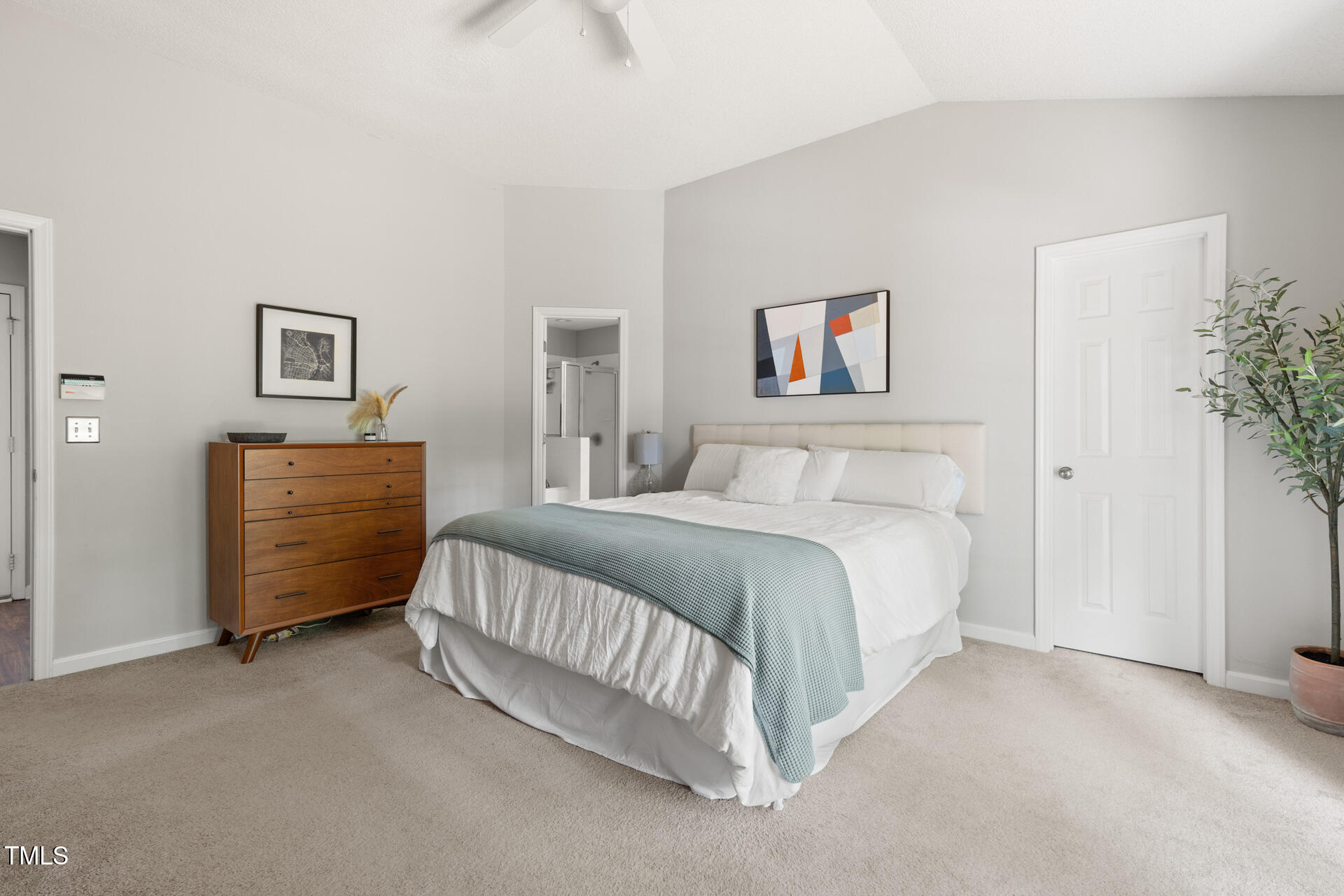 2301 Bolingbrook Lane Raleigh, NC 27613 - Photo 21 of 36 a spacious bedroom with a bed a couch and a potted plant