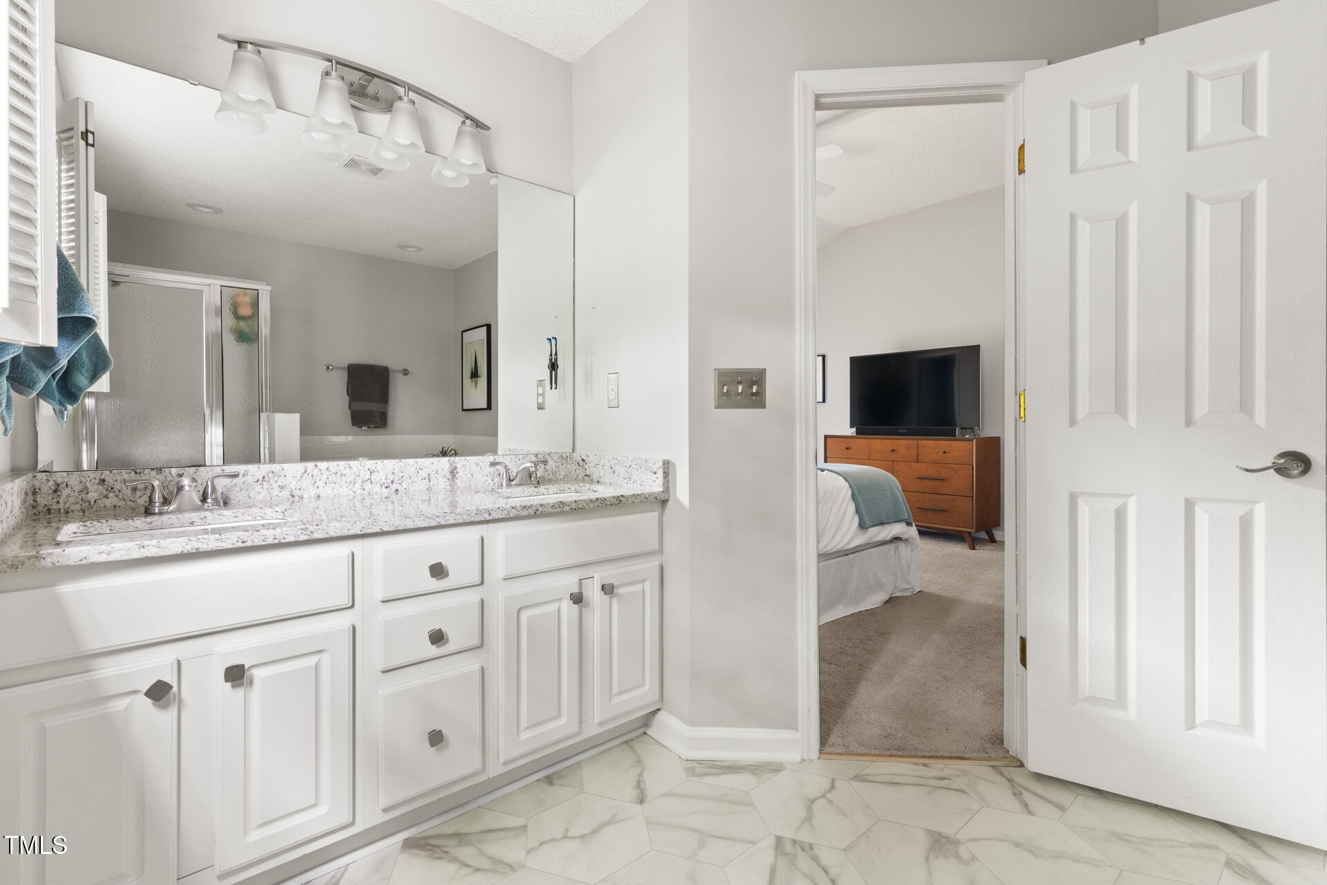 2301 Bolingbrook Lane Raleigh, NC 27613 - Photo 23 of 36 a spacious bathroom with a sink and a mirror