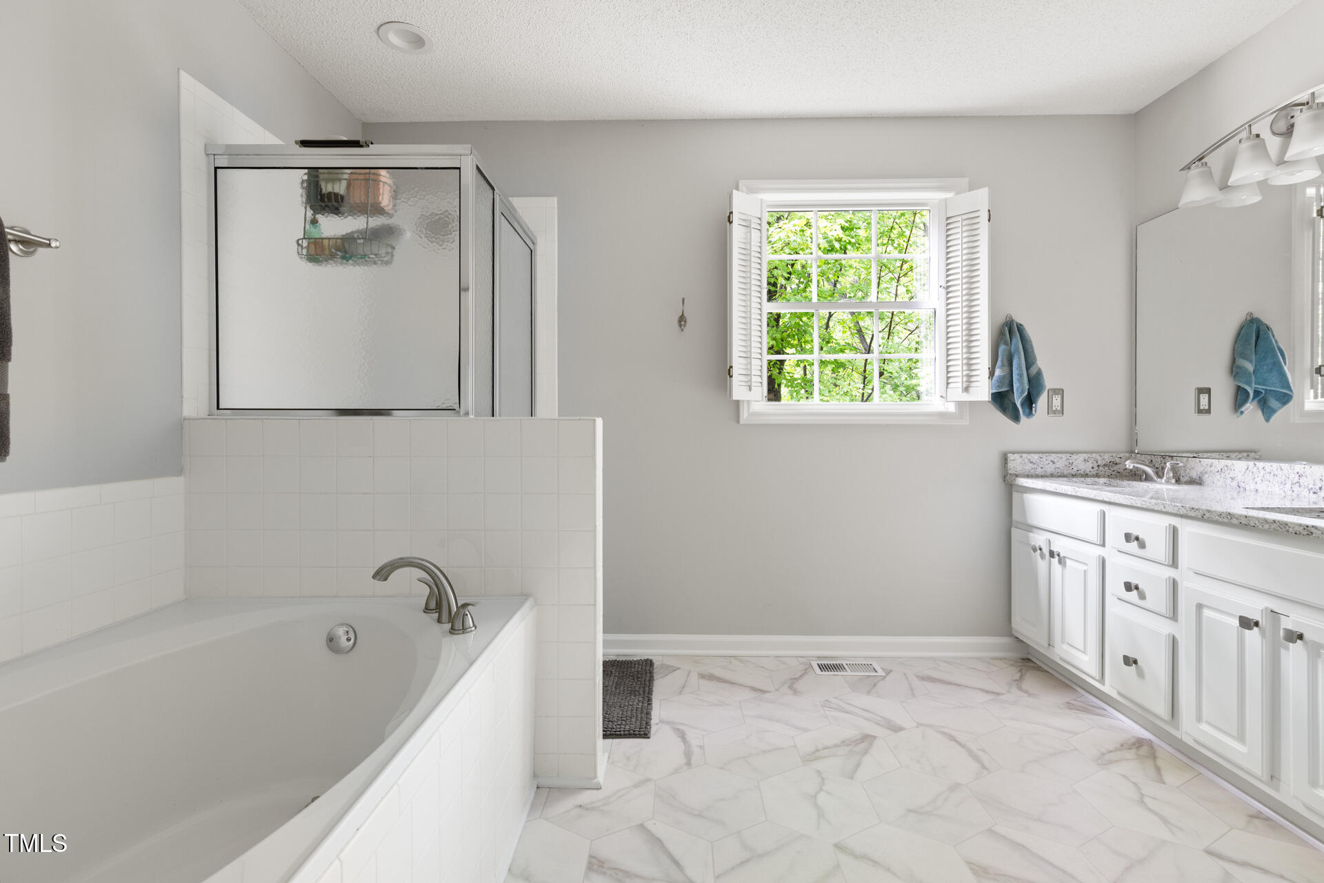 2301 Bolingbrook Lane Raleigh, NC 27613 - Photo 25 of 36 a bathroom with a tub sink and mirror