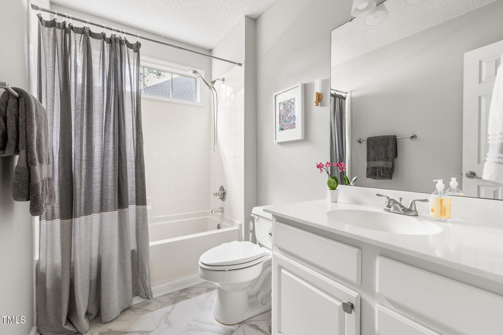 2301 Bolingbrook Lane Raleigh, NC 27613 - Photo 28 of 36 a bathroom with a sink a toilet and shower
