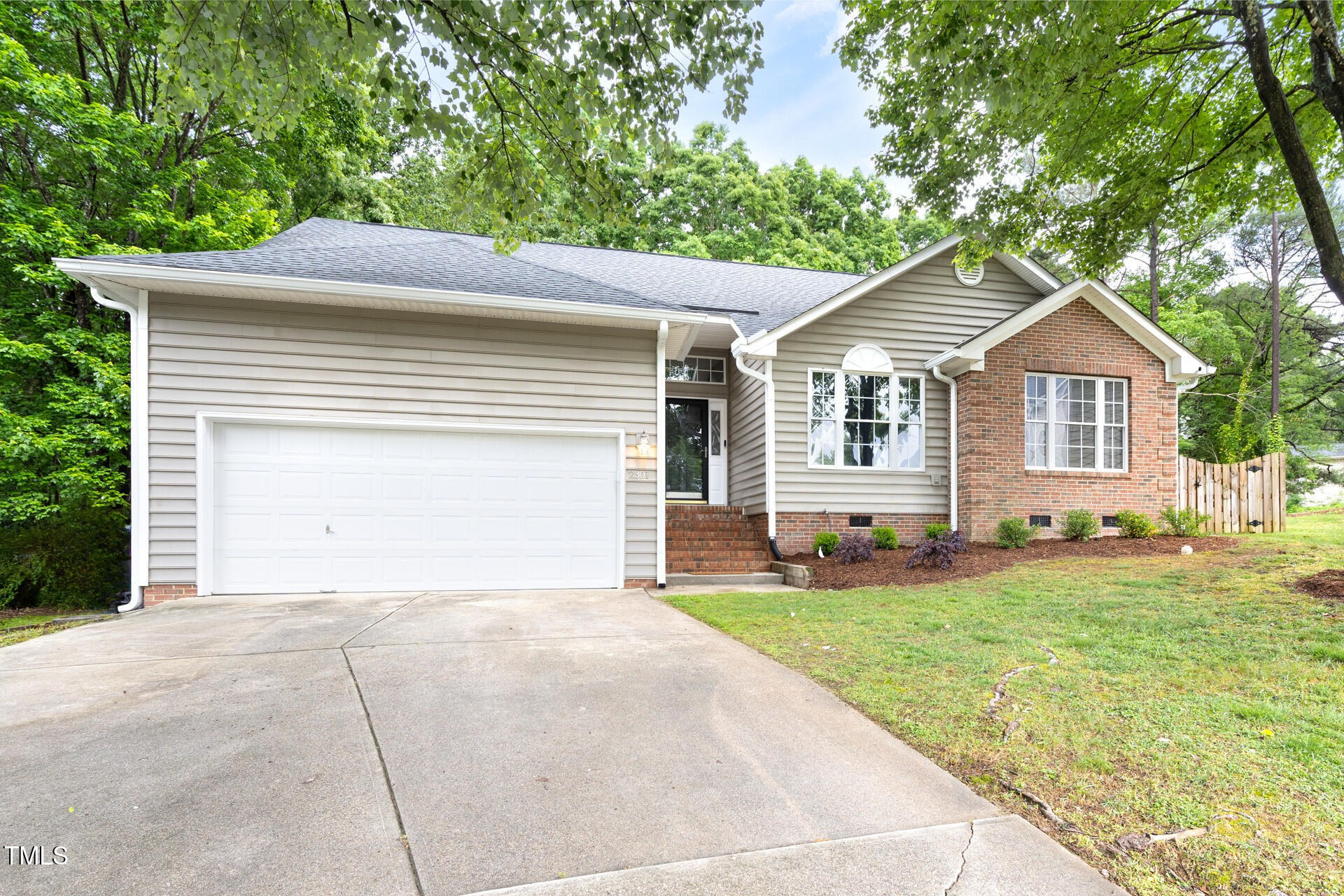 2301 Bolingbrook Lane Raleigh, NC 27613 - Photo 3 of 36 a front view of a house with a yard and garage