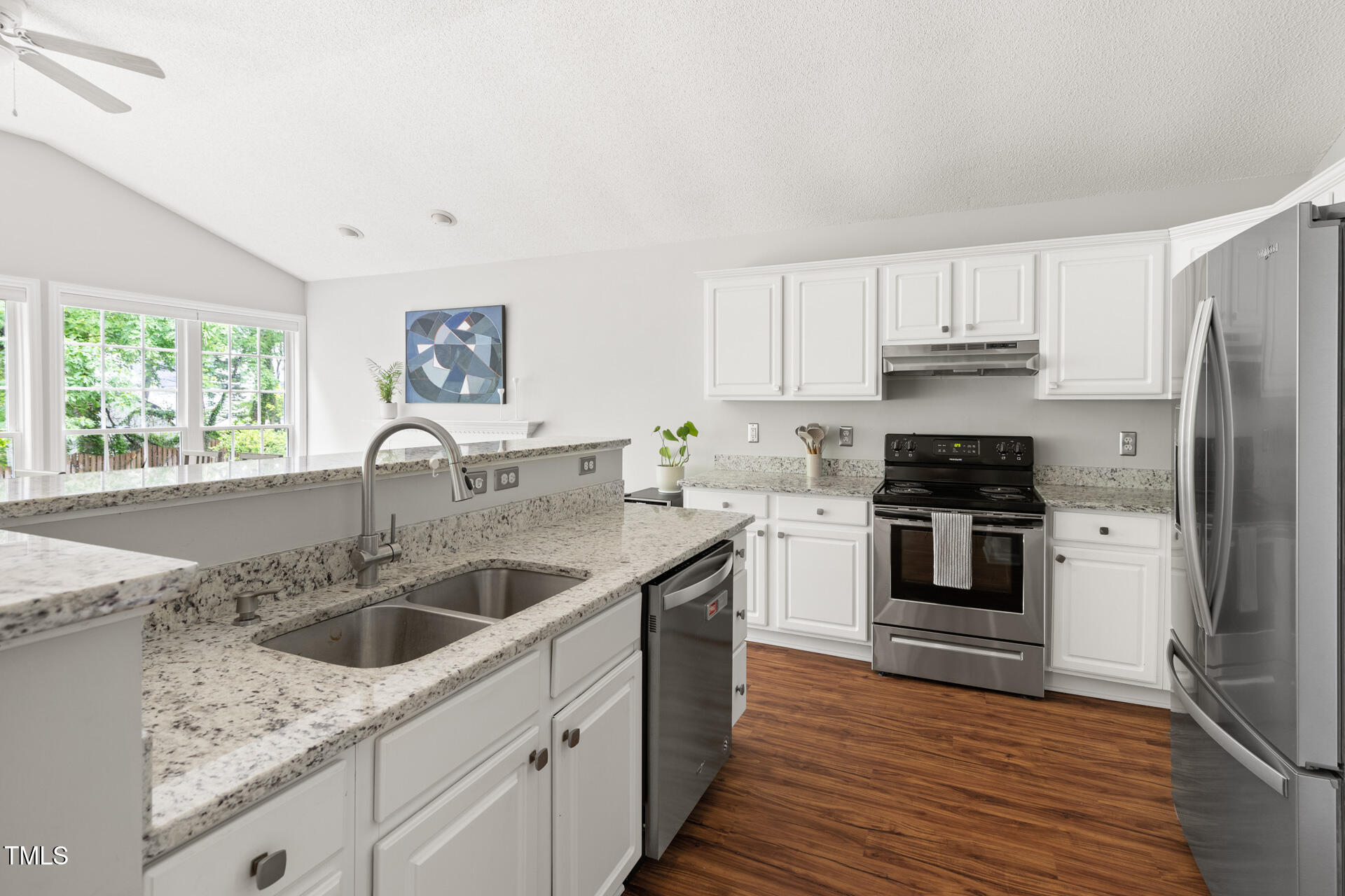 2301 Bolingbrook Lane Raleigh, NC 27613 - Photo 10 of 36 a kitchen with a sink cabinets stainless steel appliances and a window