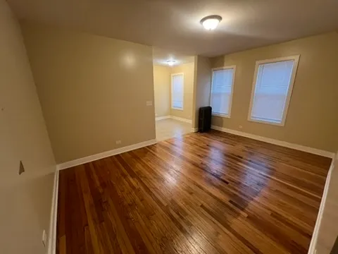 a view of a room with wooden floor and window