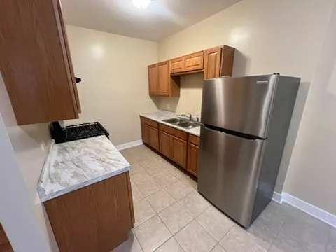 a kitchen with stainless steel appliances granite countertop a refrigerator and a stove