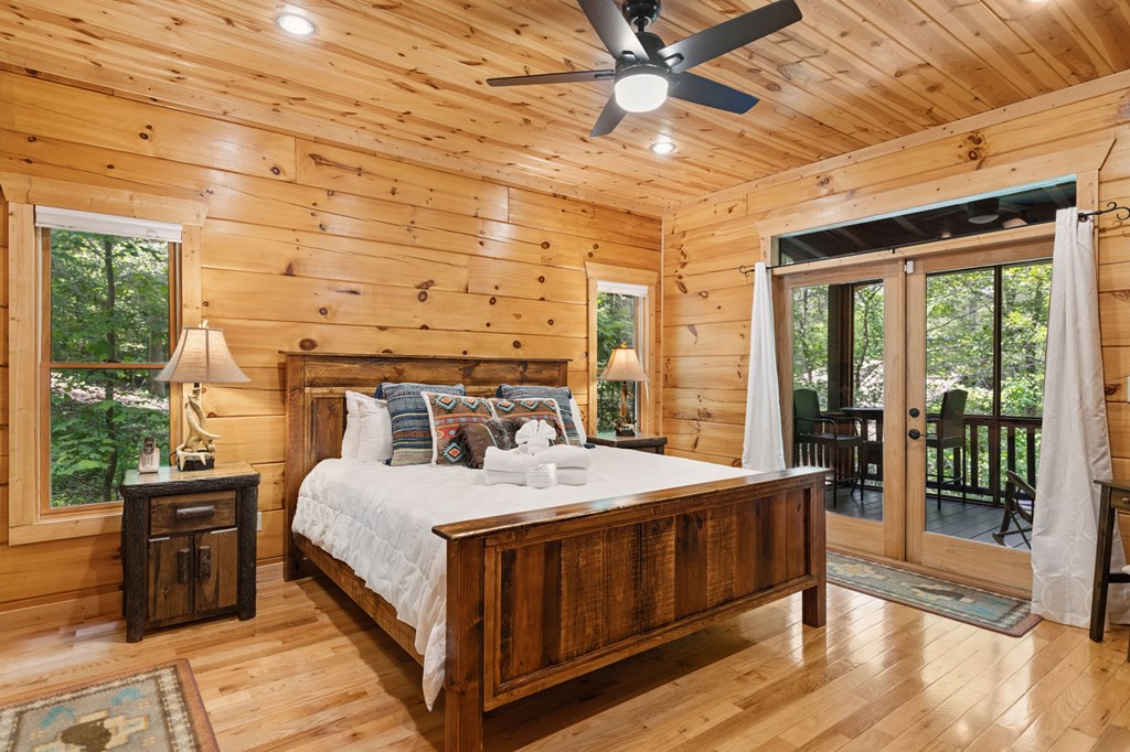 1082 Sunset Road Epworth, GA 30541 - Photo 50 of 98 a bedroom with a bed next to a large window with the outer view