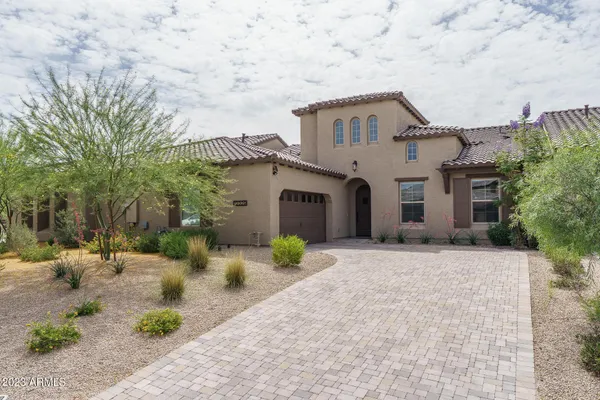 a view of a house with a yard and large trees