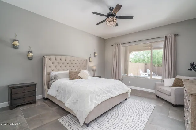 a bedroom with a bed a couch and a window