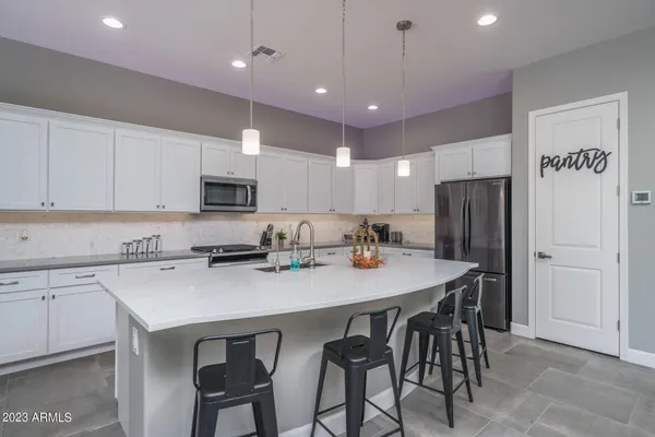 a kitchen with refrigerator cabinets and wooden floor