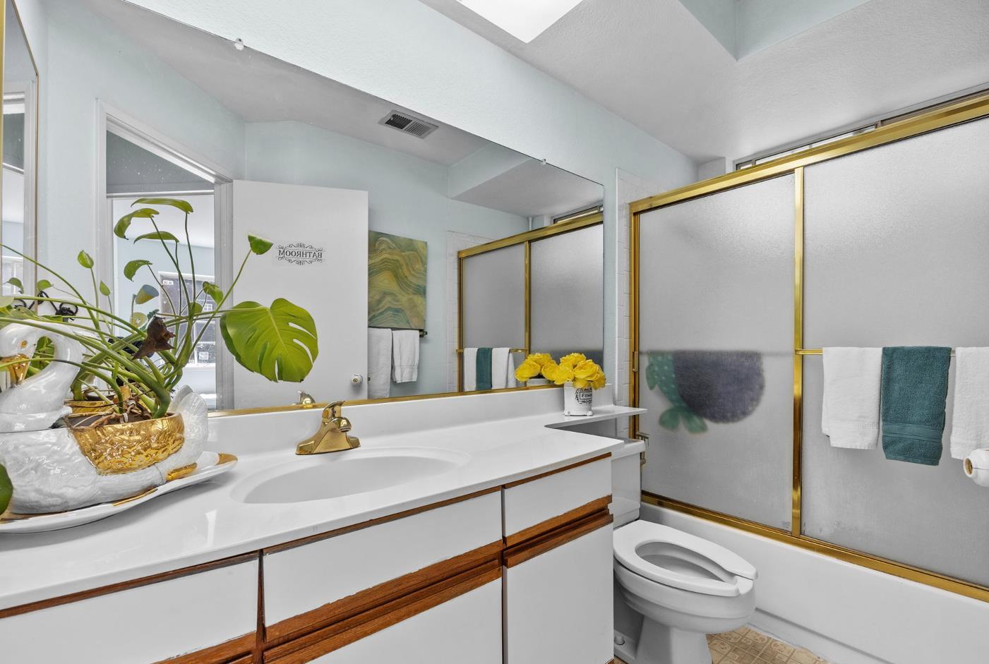 1001 Ignacio Court Pinole, CA 94564 - Photo 22 of 42 a bathroom with a granite countertop sink a toilet and mirror