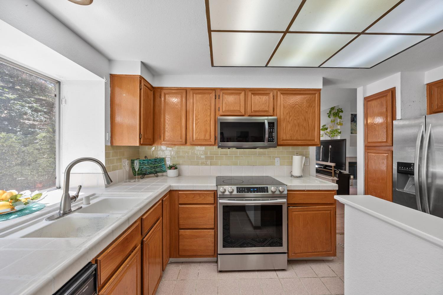 1001 Ignacio Court Pinole, CA 94564 - Photo 8 of 42 a kitchen with stainless steel appliances a sink stove and microwave