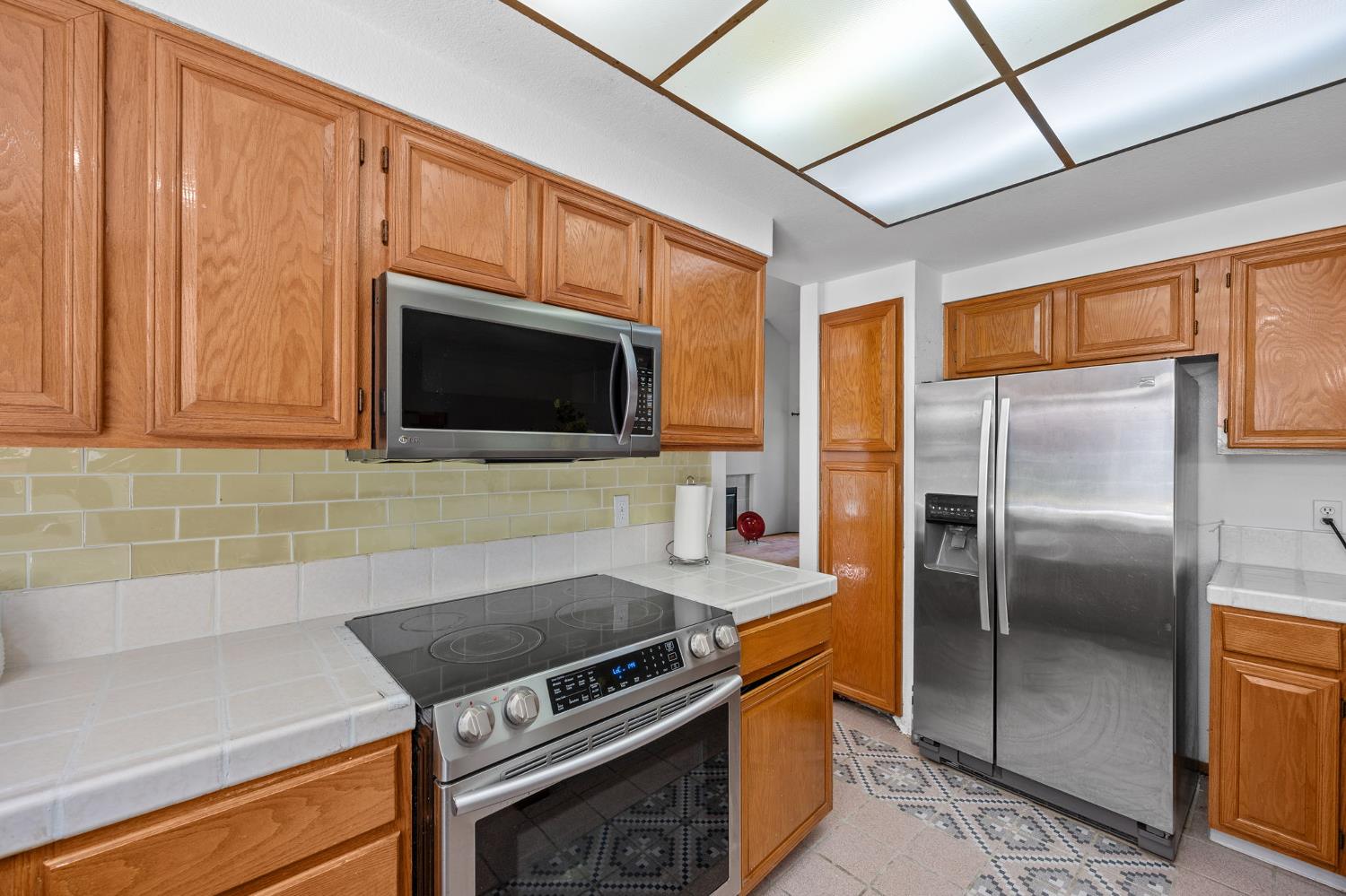 1001 Ignacio Court Pinole, CA 94564 - Photo 10 of 42 a kitchen with stainless steel appliances granite countertop a stove microwave and refrigerator