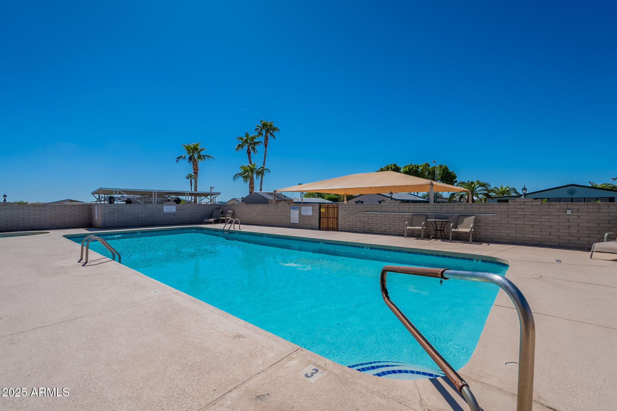 3700 South Tomahawk Road, Unit 39 Apache Junction, AZ 85119 - Photo 8 of 53 a view of a swimming pool with an outdoor space and seating area