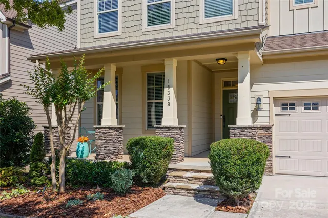 a view of a house with potted plants