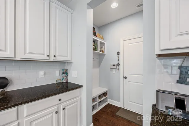 a kitchen with stainless steel appliances granite countertop a refrigerator and cabinets