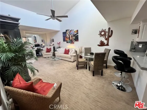 a living room with furniture gym equipment and a rug