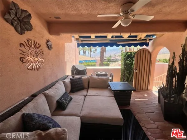 a living room with furniture and a floor to ceiling window