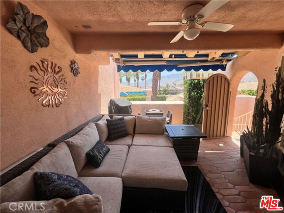 500 East Amado Road, Unit 420 Palm Springs, CA 92262 - Photo 10 of 13 a living room with furniture and a floor to ceiling window