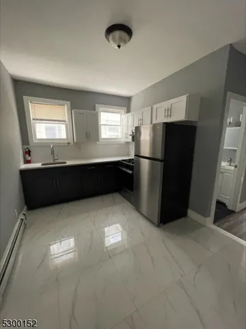 a kitchen with refrigerator and window