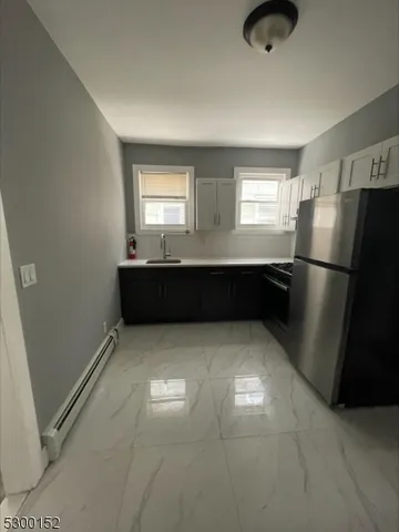 a kitchen with refrigerator and window