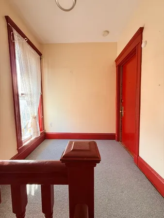 a room with a bed and a window