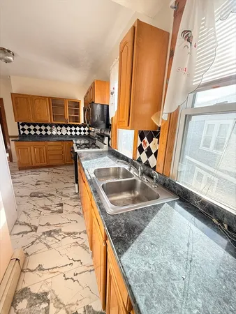 a kitchen with stainless steel appliances granite countertop a sink and a granite counter tops