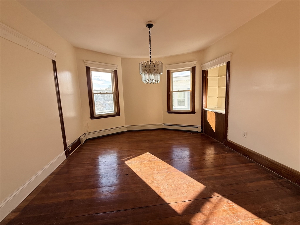 253 Norfolk Street, Unit 3 Boston, MA 02124 - Photo 5 of 14 a view of a room with wooden floor and window