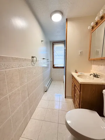 a bathroom with a sink a toilet and mirror