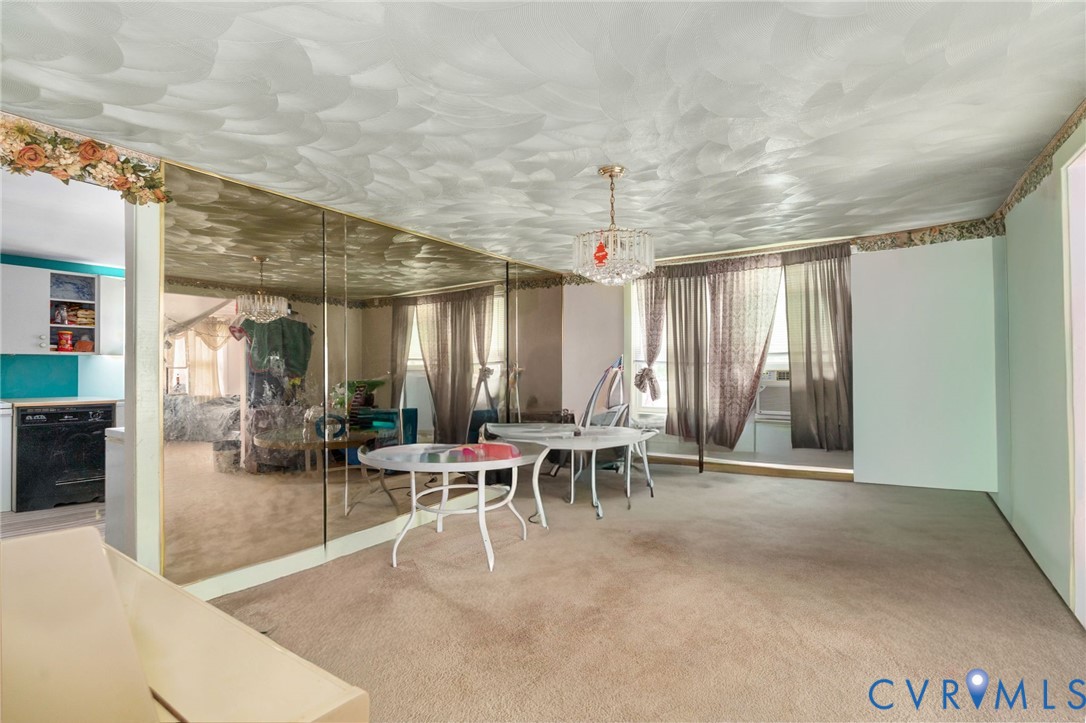 5927 Swanson Road Richmond, VA 23225 - Photo 9 of 23 Carpeted open area featuring a crystal chandelier,