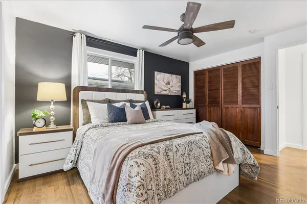 a bedroom with a bed and wooden floor