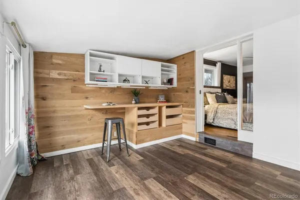 a view of a bedroom with wooden floor and closet