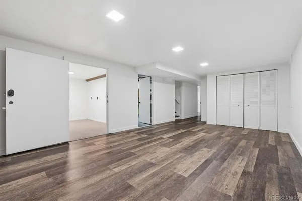 a view of an empty room and wooden floor