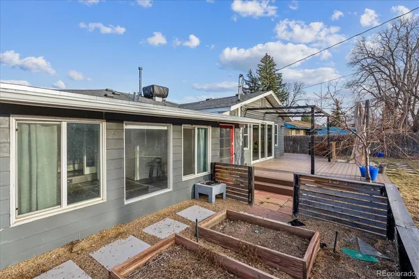 a view of a patio with couches chairs and wooden floor