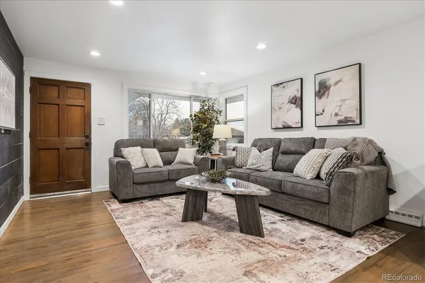 a living room with furniture and a rug