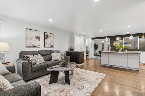 a living room with furniture and kitchen view