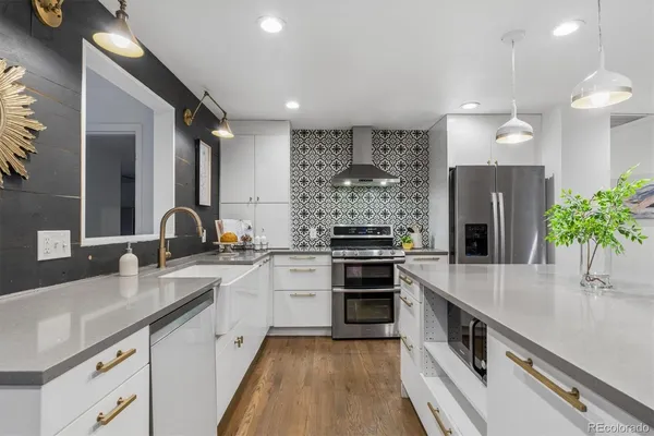 a kitchen with stainless steel appliances a sink stove and cabinets