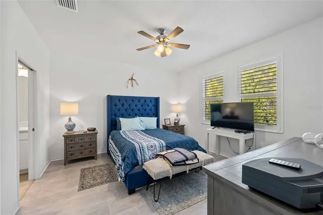 a bedroom with a bed and a flat screen tv